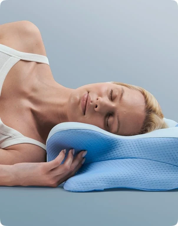 Seller illustration of a woman resting on her side on the contoured Ergo Pillow